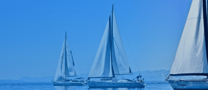 Three yachts floating in the sea